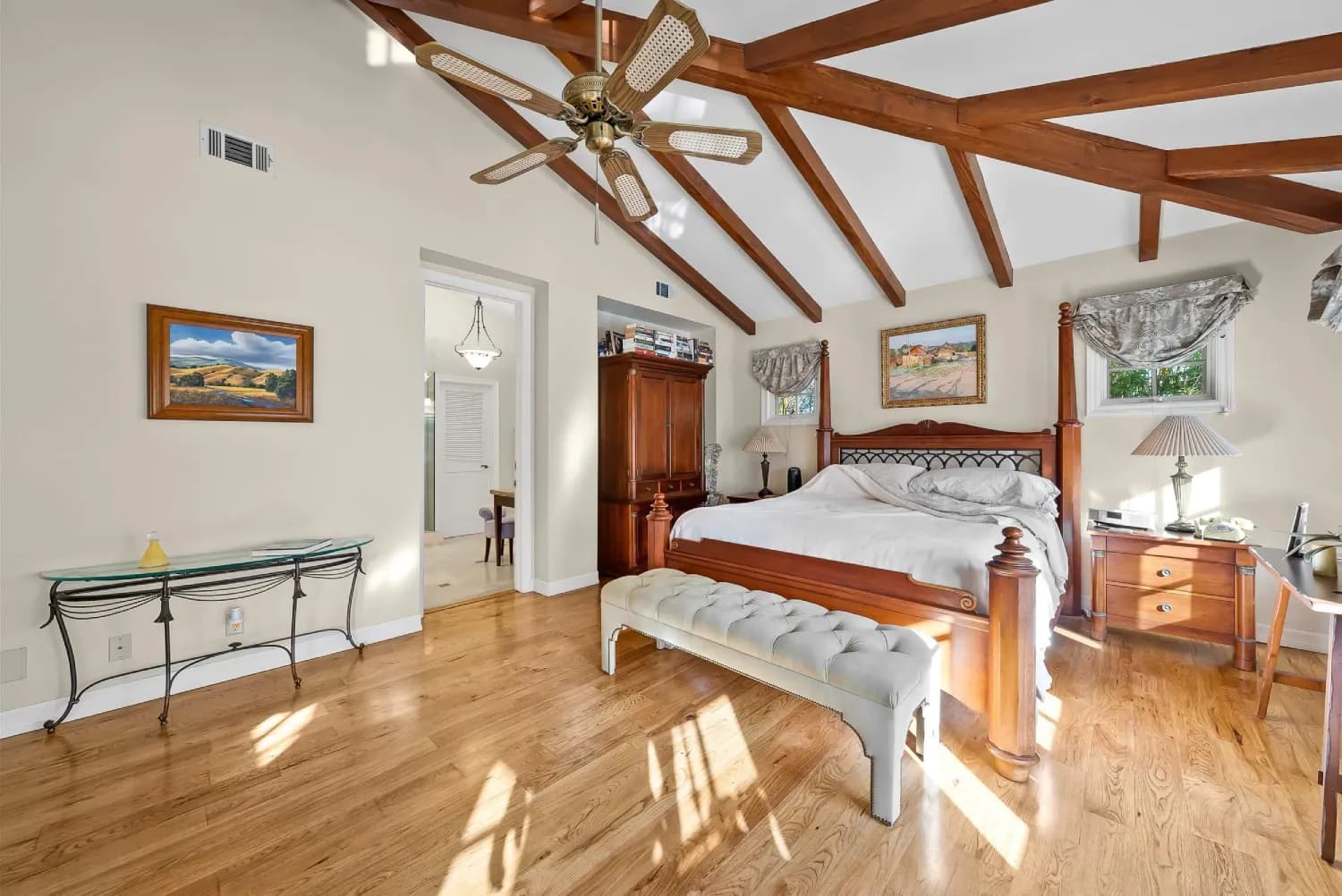 Spacious bedroom suite with cathedral beamed ceiling and oak hardwood flooring