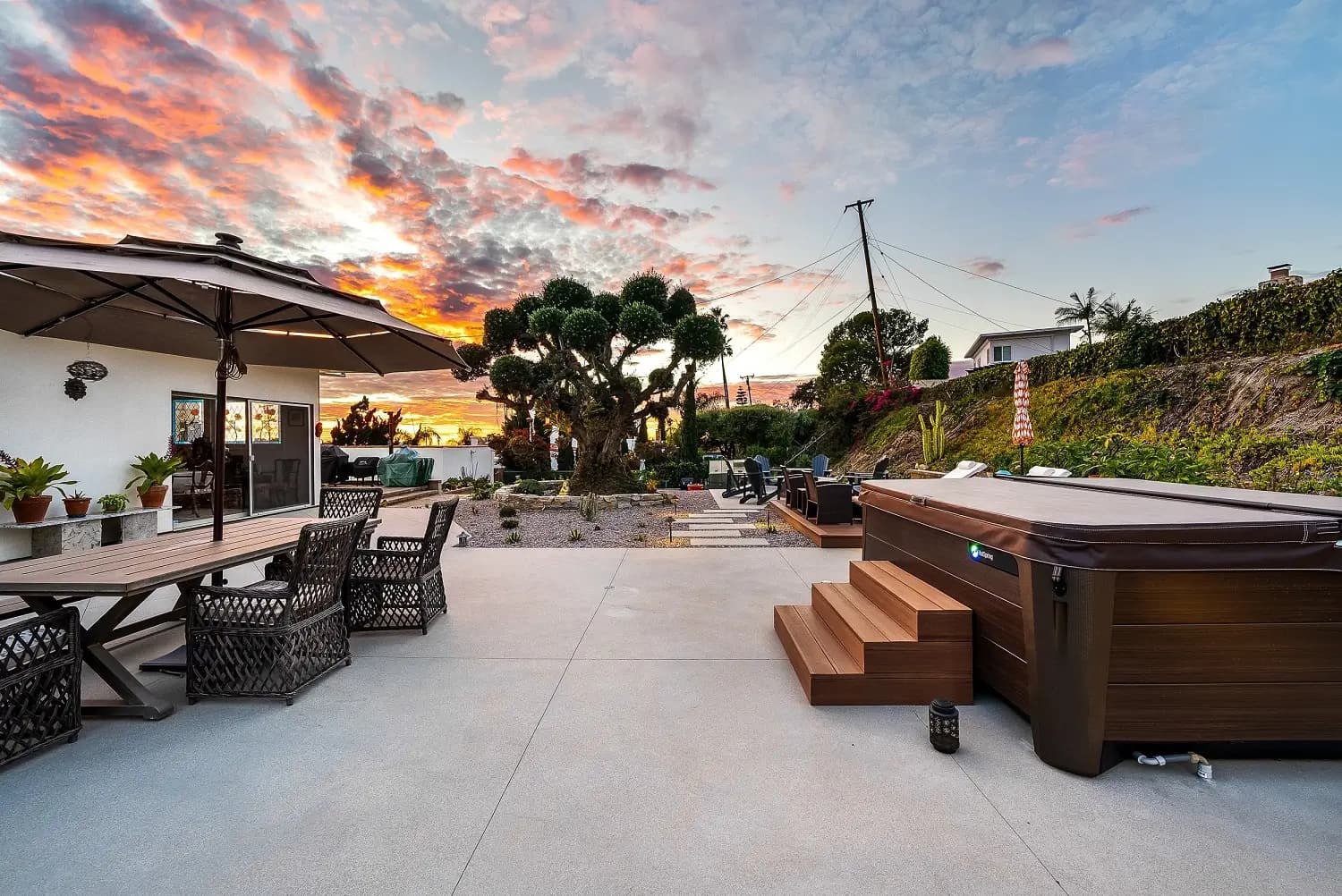 Built-in spa and dining patio on a hillside Palos Verdes backyard at dusk