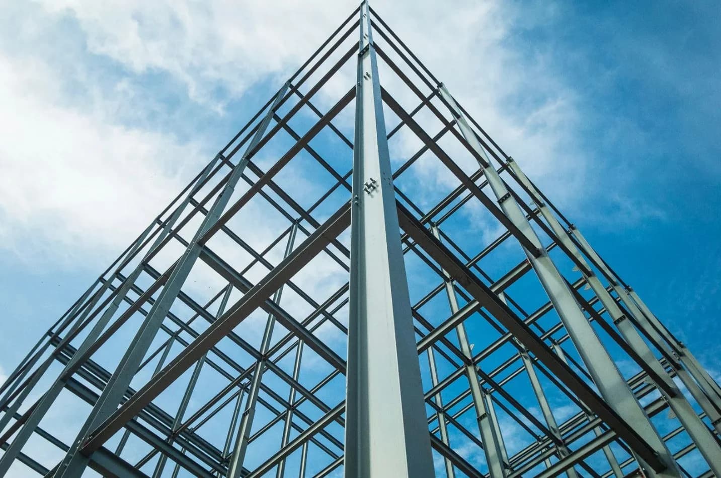 Steel structural framing of a building rising against a blue sky