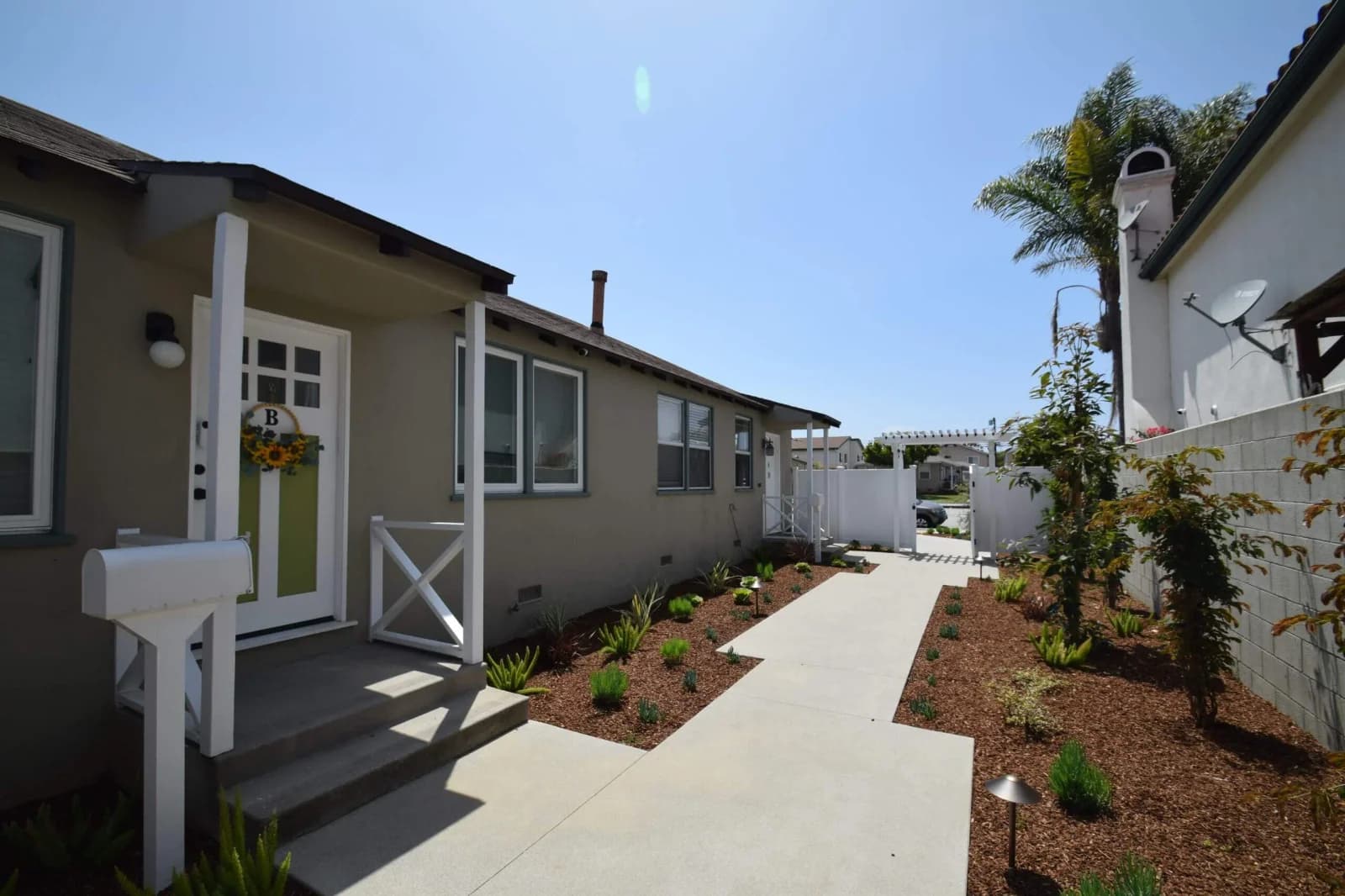 Cabrillo Bungalows entry walkway with covered porch and freshly planted landscaping