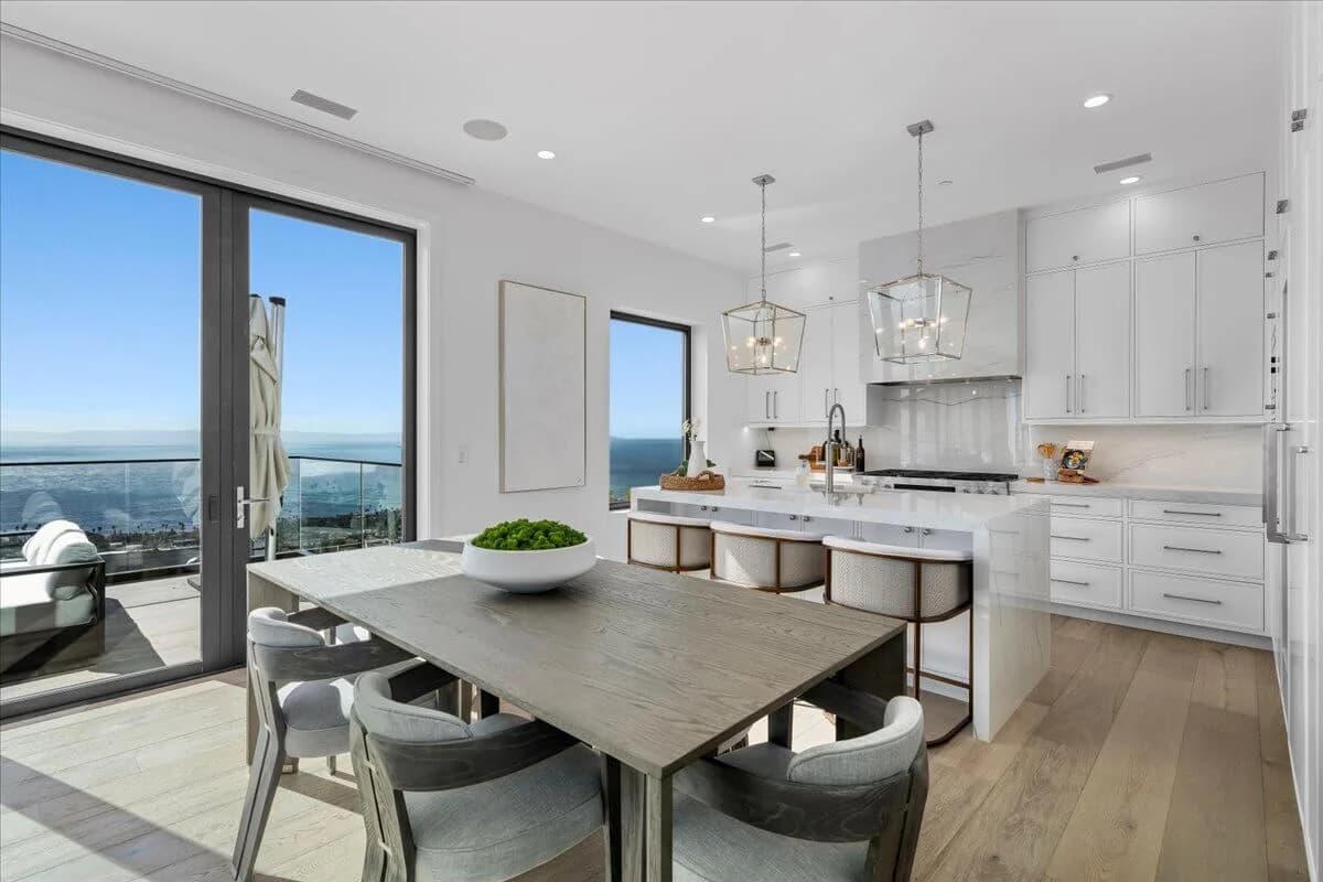 Open kitchen and dining area with ocean view through sliding glass doors