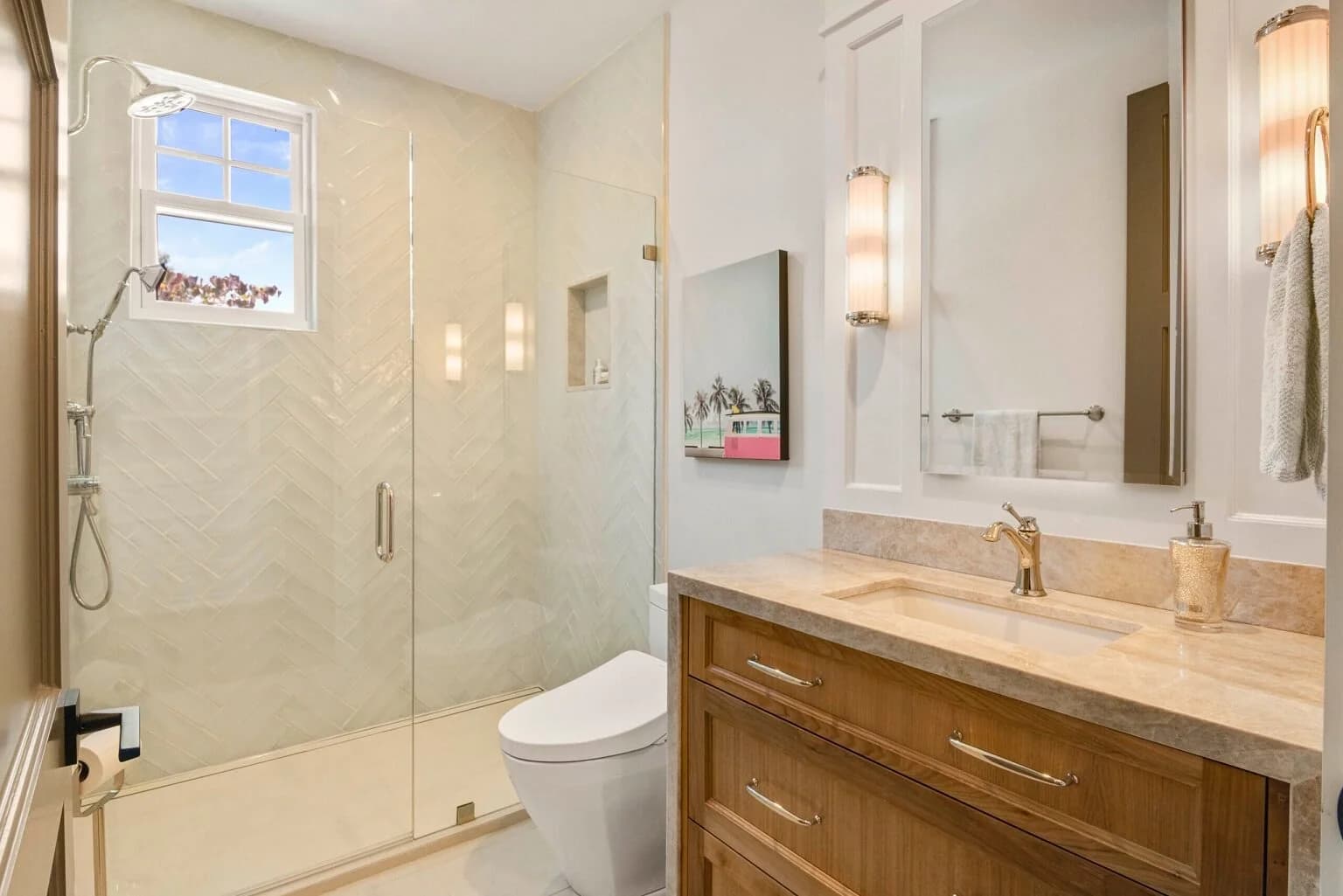 Guest bath with glass shower, herringbone tile, walnut vanity, and stone countertop