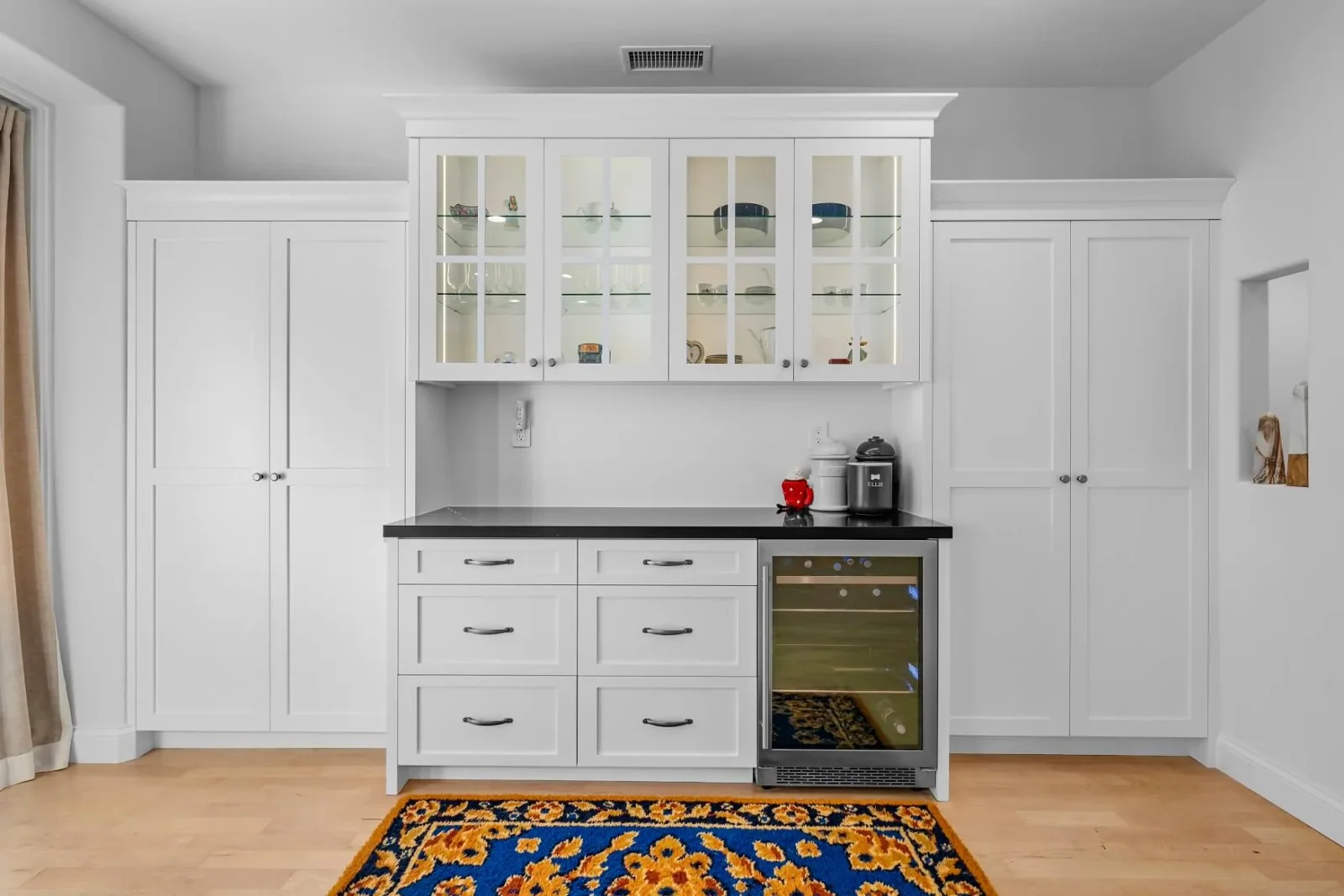Symmetrical built-in hutch with glass cabinets and integrated beverage fridge