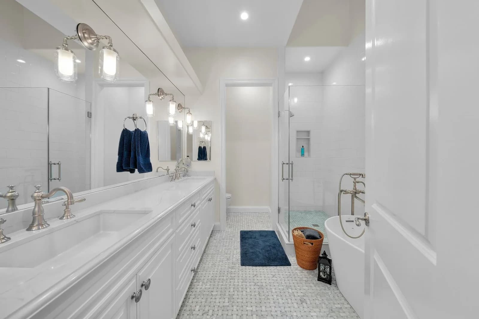Spa-style primary bathroom with corner shower, soaking tub and marble tile floor