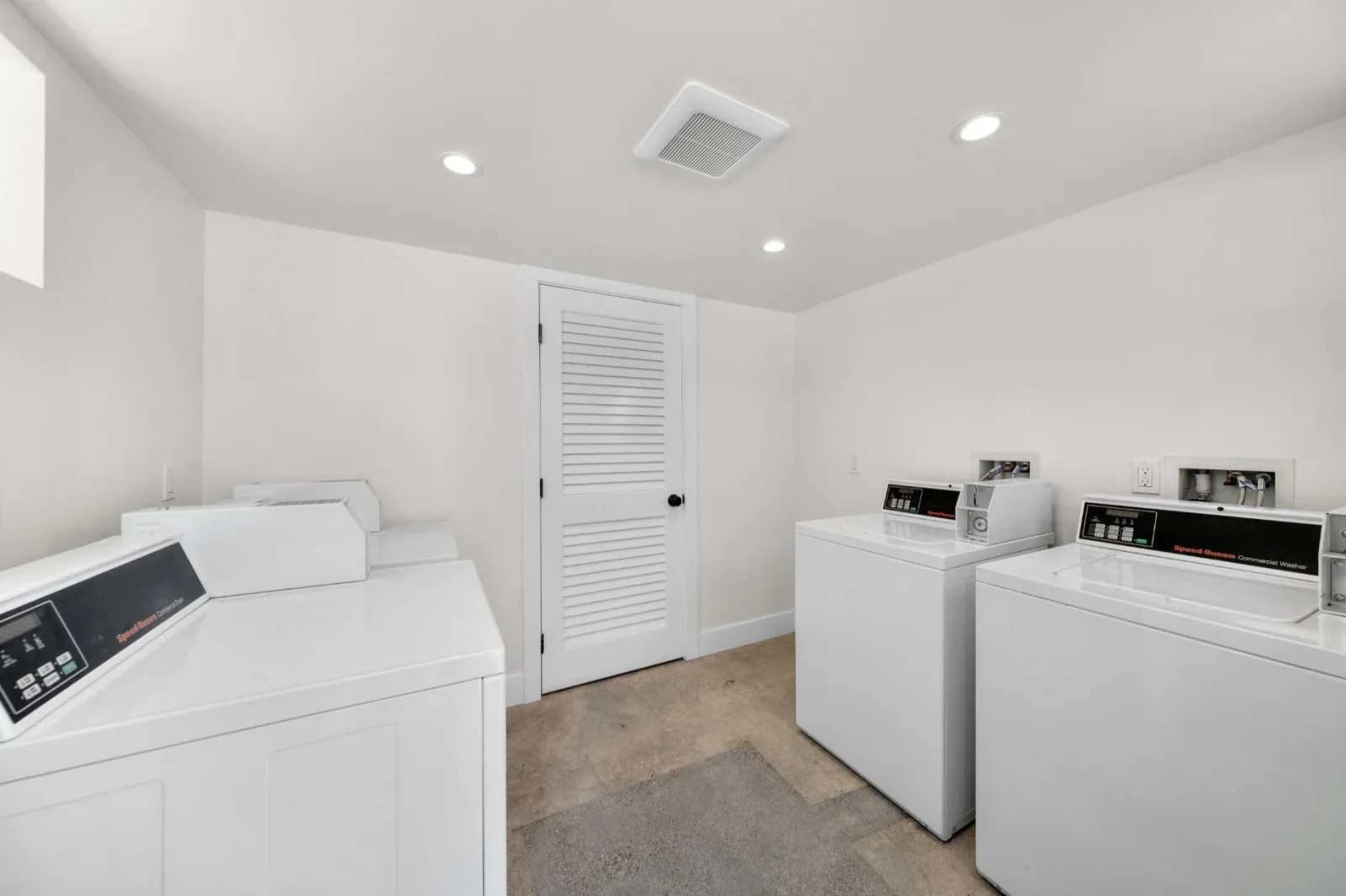 Shared laundry room with commercial-grade Speed Queen washers and dryers