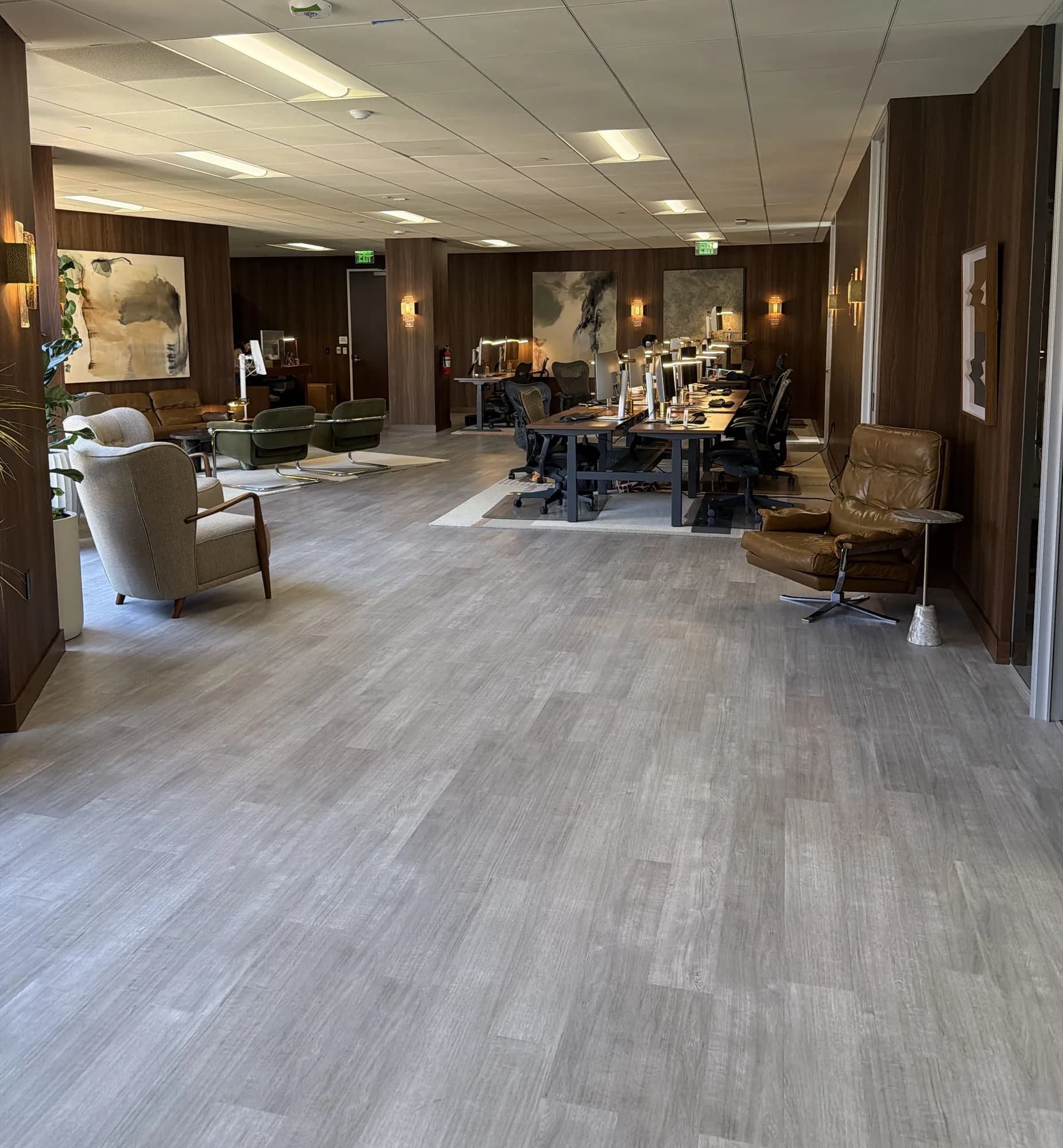 Open-plan office with workstation benches and lounge chairs