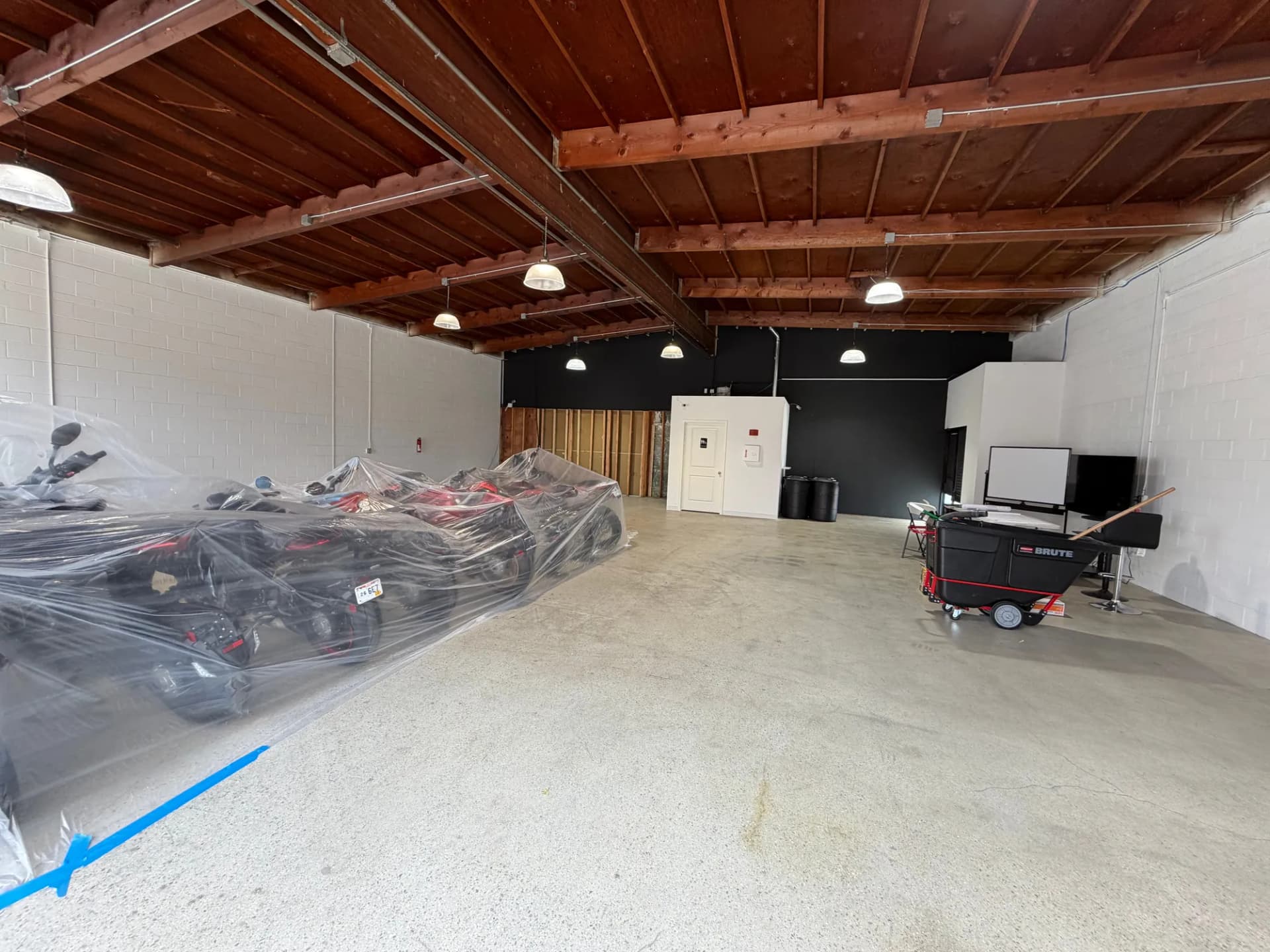 MV Agusta showroom space with motorcycles wrapped and the floor protected before an office build-out