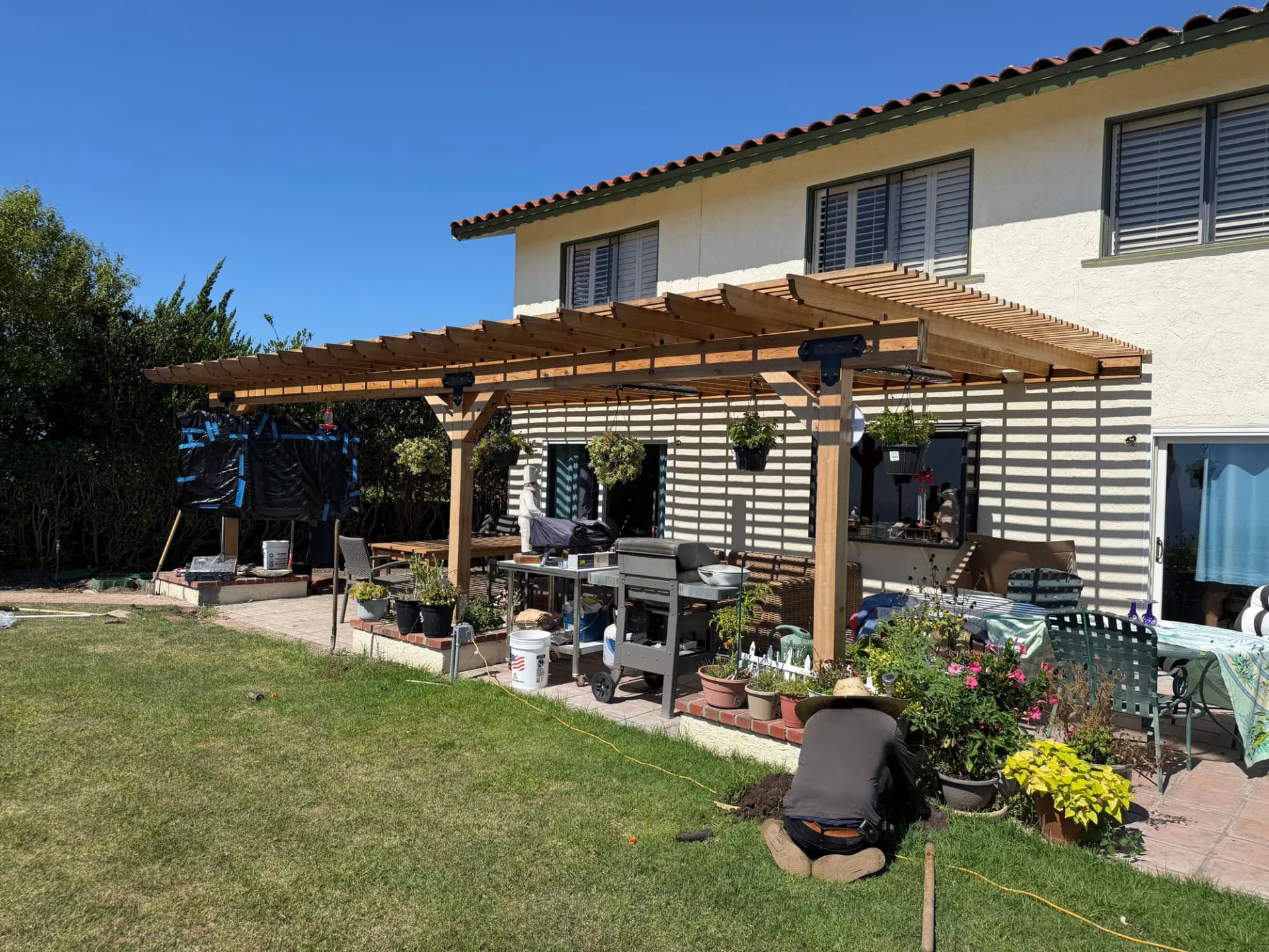 Clear redwood pergola with infrared heaters over a backyard patio in Rancho Palos Verdes