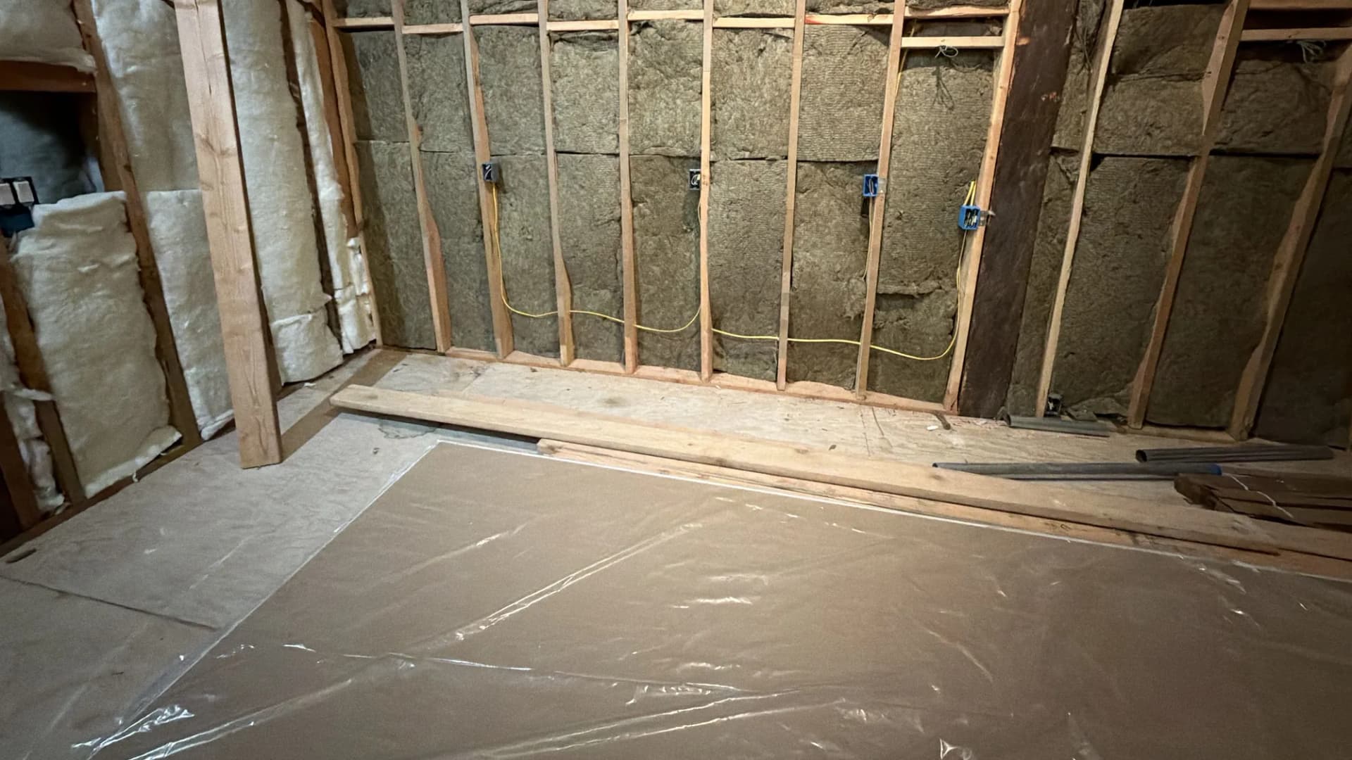 Insulated framed wall with electrical boxes ahead of drywall