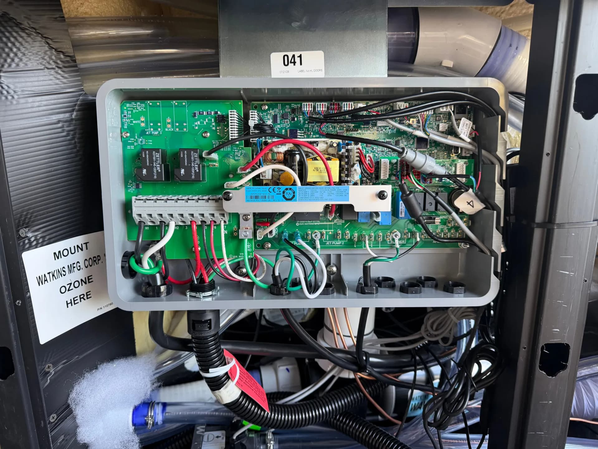 Hot tub control board with supply conductors landed on its terminal block