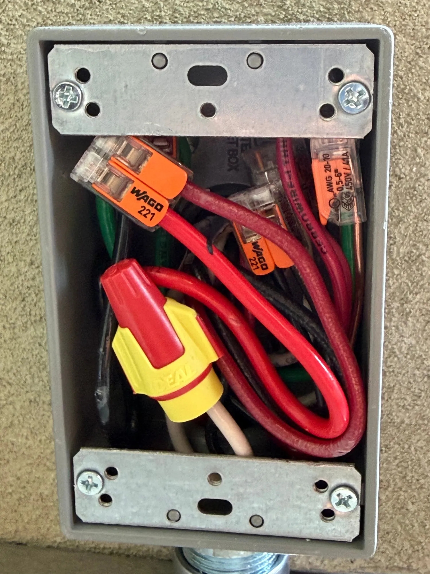Weatherproof junction box with conductors joined by lever connectors