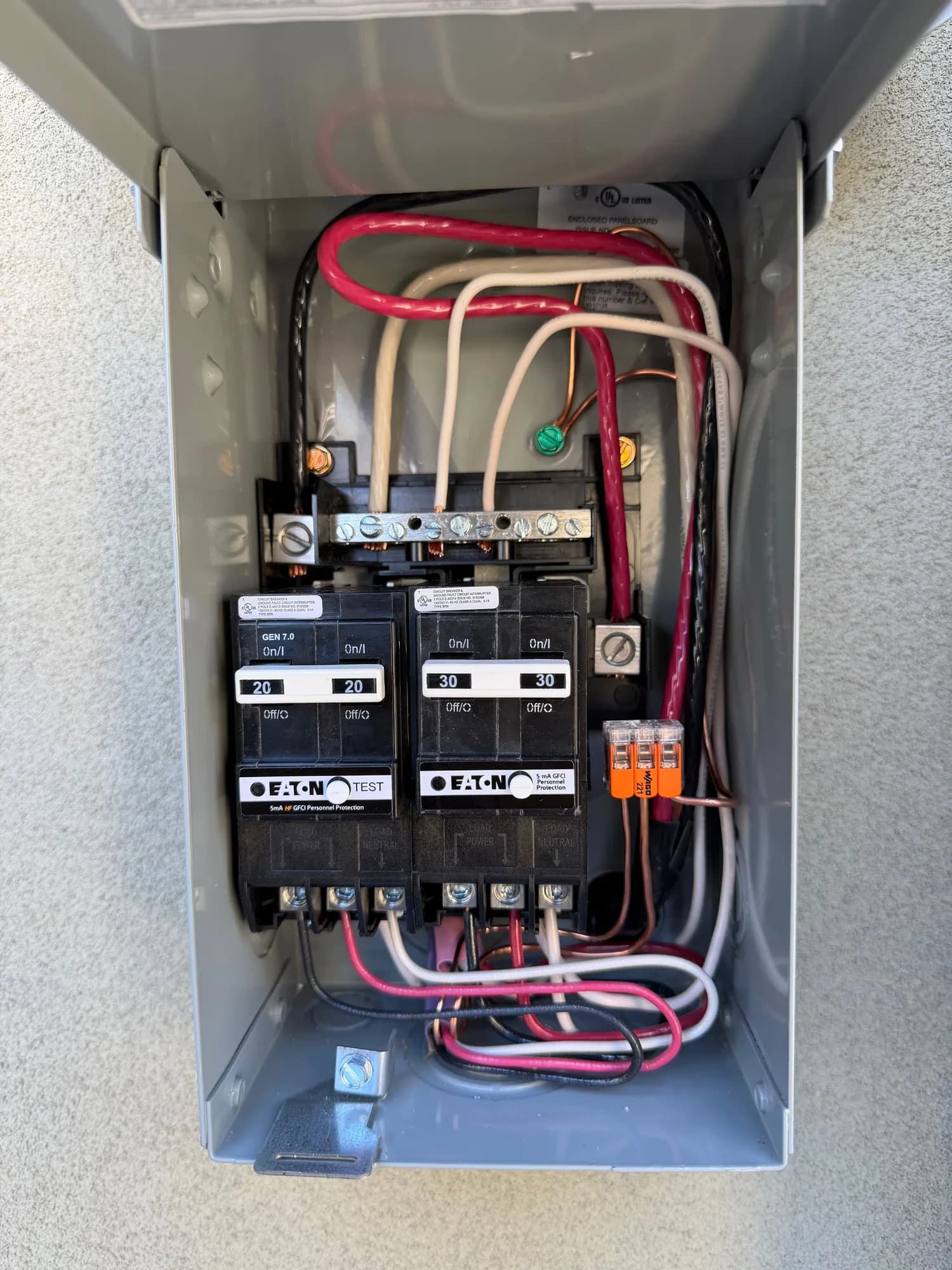 Open spa disconnect subpanel with two GFCI breakers and neatly landed conductors