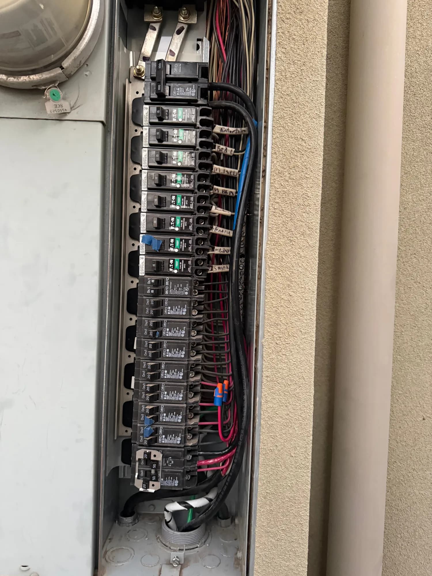 Main panel interior with new breakers installed and labeled circuits